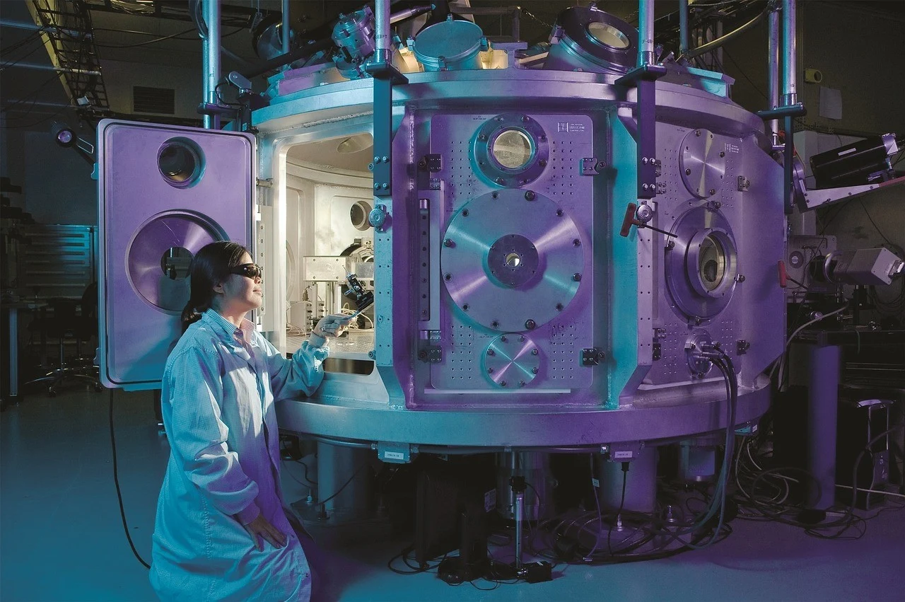 Scientist presenting in front of large machine